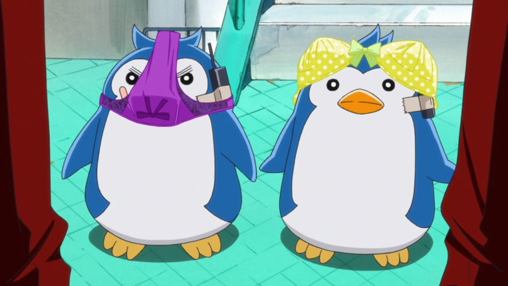 Kanba and Shouma's penguins with underwear on their heads. One has a yellow bra with white polka-dots, the other has bright purple thong. Both have walkie-talkies taped to their heads.